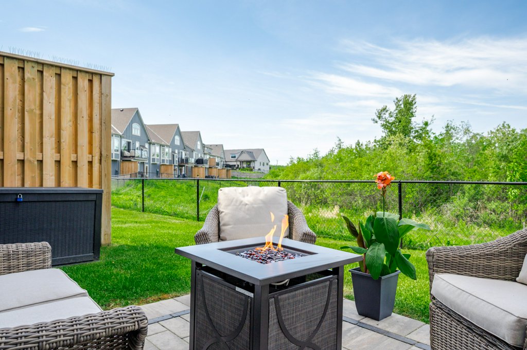 80 Marsh Avenue, Unit 78 - Patio with fire pit and wicker armchairs