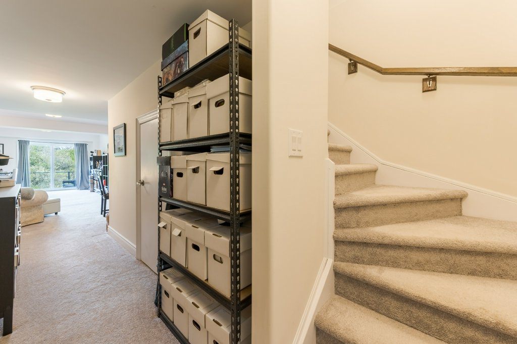 80 Marsh Avenue, Unit 78 - Basement hallway with storage shelving
