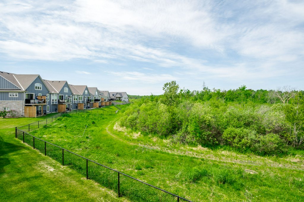 80 Marsh Avenue, Unit 78 - Exterior view of the townhomes backing onto greenspace