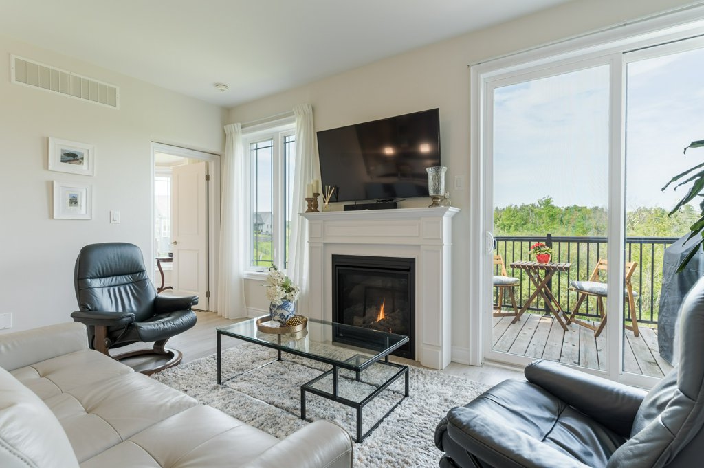 80 Marsh Avenue, Unit 78 - Living room with fireplace and balcony doors